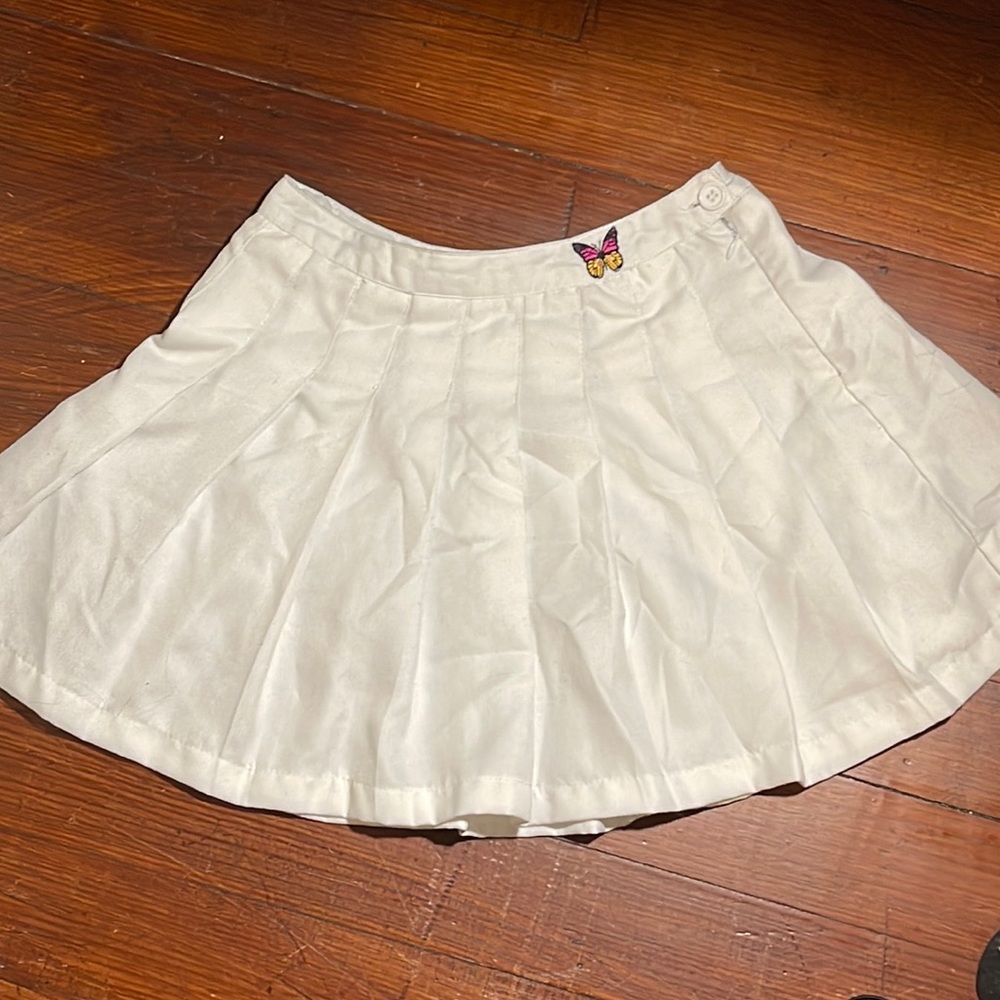 white skirt (zipper works) with butterfly on the waist band.